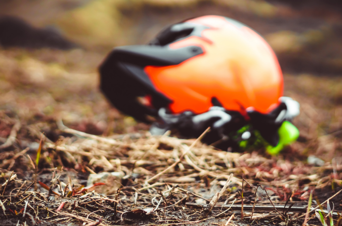 orange helmet on ground with gloves