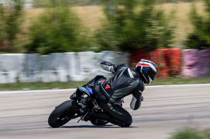 person racing with black motorcycle helmet